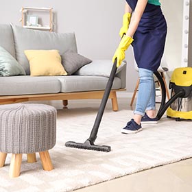 cleaning company in Nottingham, photo of person cleaning a white carpet.