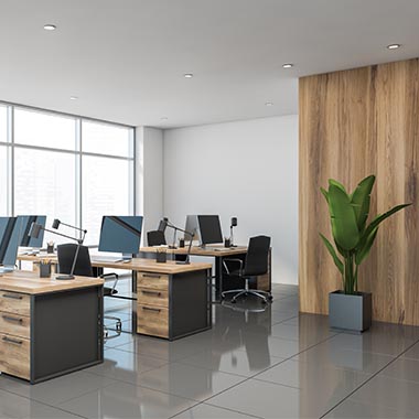 cleaning company in Nottingham, photo of modern clean office room with computers, wooden desks and a house plant.